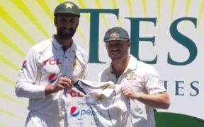 David Warner receives a signed shirt belonging to Babar Azam