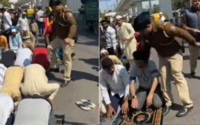 an Indian police officer severely assaults two Muslim men who are praying on Friday