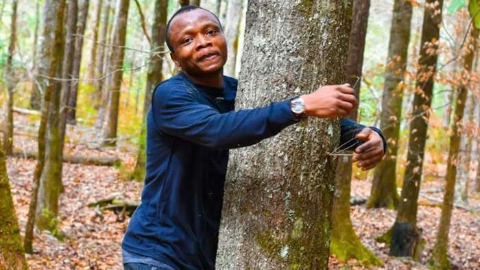 An environmentalist from Ghana smashes the world record by hugging over 1,100 trees in one hour